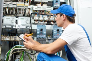 Young adult electrician builder engineer inspecting electric cou